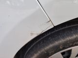 a close up of a tire on a white car