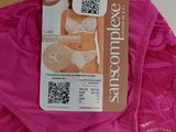 a pink underwear with a tag on it and a pair of scissors