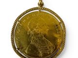 a close up of a gold coin with a chain around it