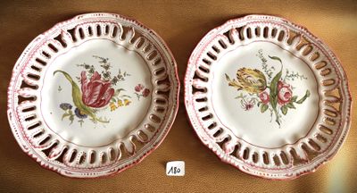 two plates with flowers on them on a table