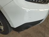 a close up of the front bumper of a white car