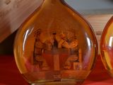 two glass vases with pictures of people inside of them