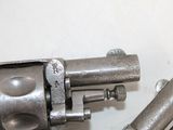 a gun that is sitting on a table next to a pair of screws