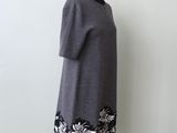 a woman ' s grey dress with black and white flowers on it