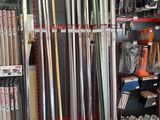 many different types of baseball bats on display in a store
