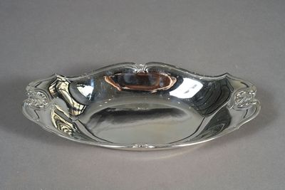 a silver plate with a gold decoration on it