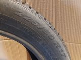 a close up of a tire on a cardboard box with a cardboard box in the background