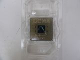 a small processor in a plastic container on a white surface