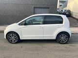a white car parked on the side of the road in front of a building