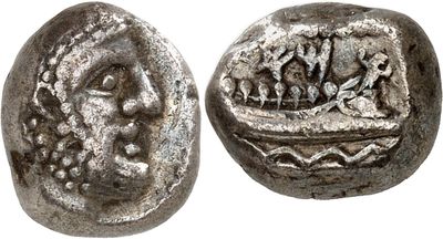 a close up of a silver coin with a face on it