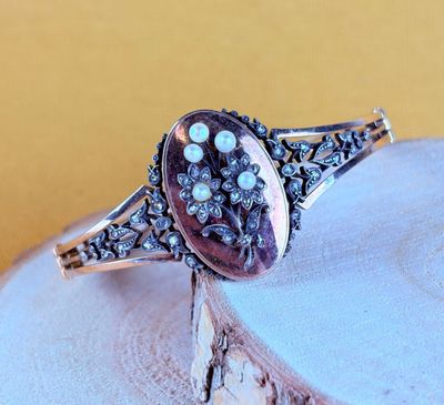 a close up of a silver ring with a stone in it
