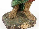 an image of a statue of a man sitting on top of a wooden block