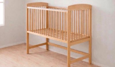 a baby crib in the corner of a room next to a window