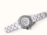 a close up of a watch on a white surface