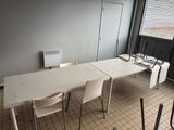 a white table and chairs in a room with a window