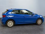 the blue car is parked in a room with a gray floor