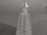a clear glass christmas tree on a table