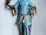 a statue of a man holding a candle in his hand