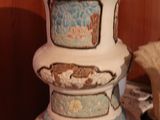 a white vase with a blue and white design on it