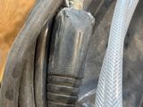 a close up of a hose connected to a wooden fence