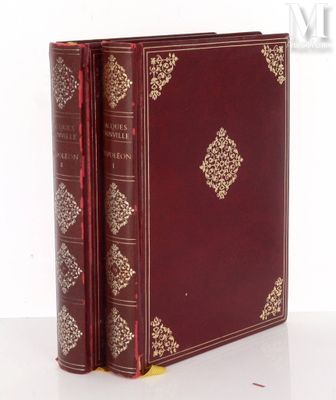 an old book sitting on top of a white table next to a white wall