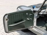a green car with its door open on the street