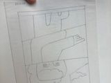 someone is holding a piece of paper with a drawing of a man on it