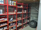 many shelves with various items on them in a garage