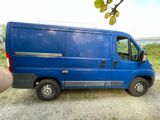 a blue van parked on the side of the road