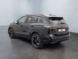 the rear end of a black suv parked in a room