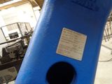 a blue pipe with a black hole in it