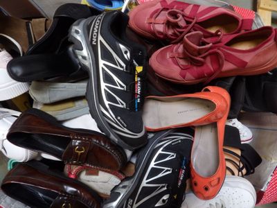many pairs of shoes that are sitting on the floor