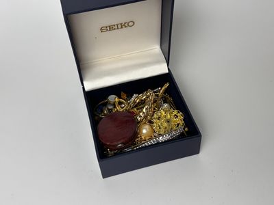 an image of a box with some gold and red items in it