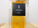 a close up of a bottle of perfume on a wooden table