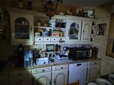 a kitchen with a microwave, dishwasher, and other items on the counter