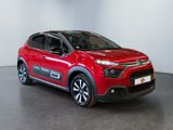 the red citrole is parked in a large room
