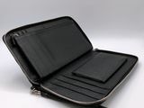 an image of a black wallet with a phone inside of it