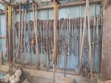 a lot of tools that are hanging on the wall