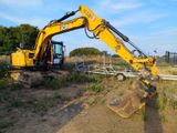 a yellow excavator that is sitting in the dirt