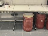 a photo of a table with two red drums on it