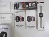 several smart watches are displayed on a white surface with boxes