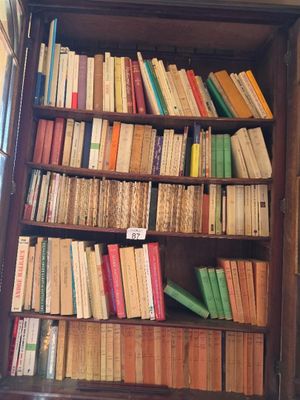 a book case with many books on the shelves