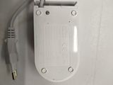 a white box with a white cord attached to it