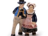 a figurine of a man and a woman riding a camel