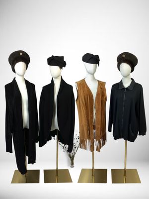 three mannequins dressed in black, brown, and white outfits
