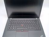 the open laptop is sitting on a white surface with a black keyboard