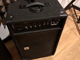 a black amp sitting on a hard wood floor in a room