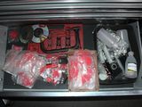 a drawer full of assorted items in a car