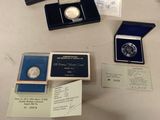 some of the silver coins are sitting on a table with other items