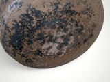 a brown vase that is sitting on a white surface